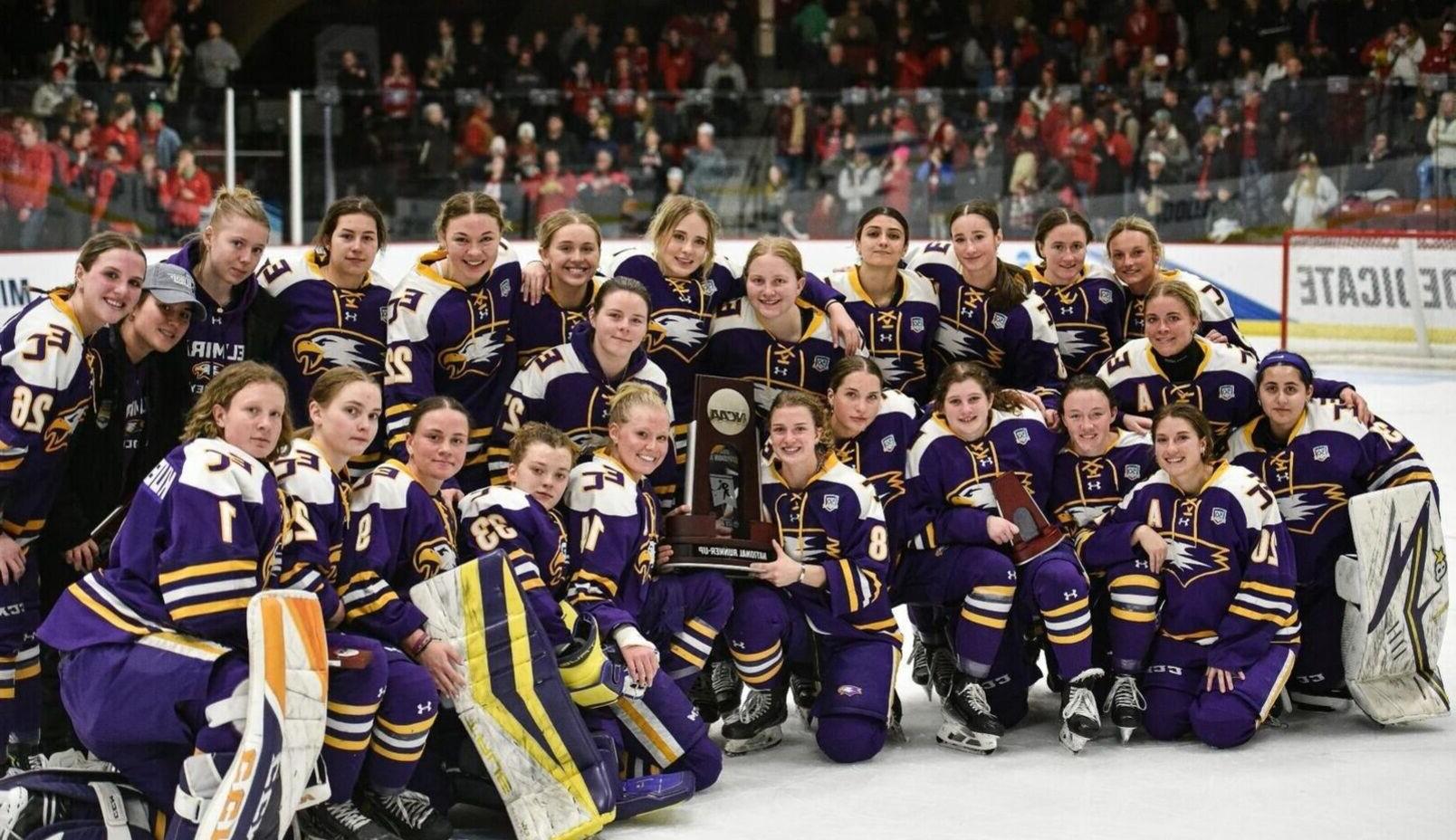 The Elmira College Women's Hockey Team poses together with an NCAA trophy after coming in second in the nation.